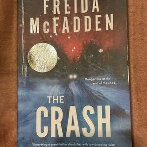 The Crash by Freida McFadden - Blue & Red Thriller Paperback